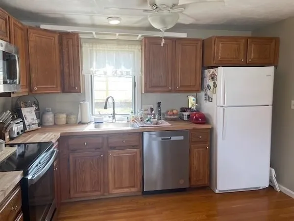 a kitchen with a sink a refrigerator and cabinets