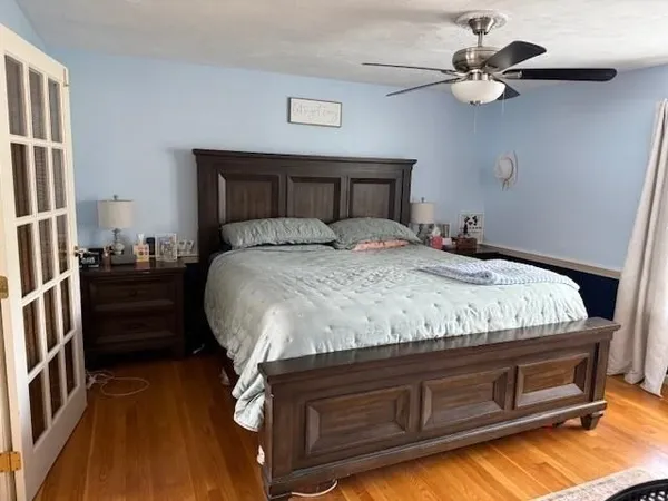 a bedroom with a bed and a chandelier