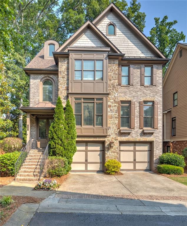 7987 Magnolia Square Sandy Springs, GA 30350 - Photo 1 of 1 a front view of a house with a yard and garage