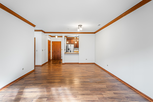 10 Ford Street, Unit 103 Geneva, IL 60134 - Photo 7 of 7 a view of a room with wooden floor and white walls