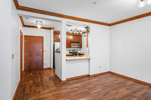 10 Ford Street, Unit 103 Geneva, IL 60134 - Photo 4 of 7 a view of a hallway with wooden floor and a bathroom