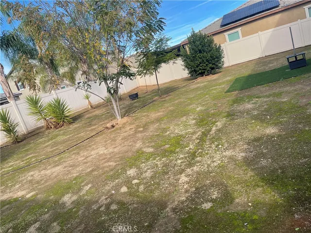 a kitchen with granite countertop a refrigerator and a sink