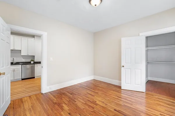 a view of kitchen with wooden floor and electronic appliances