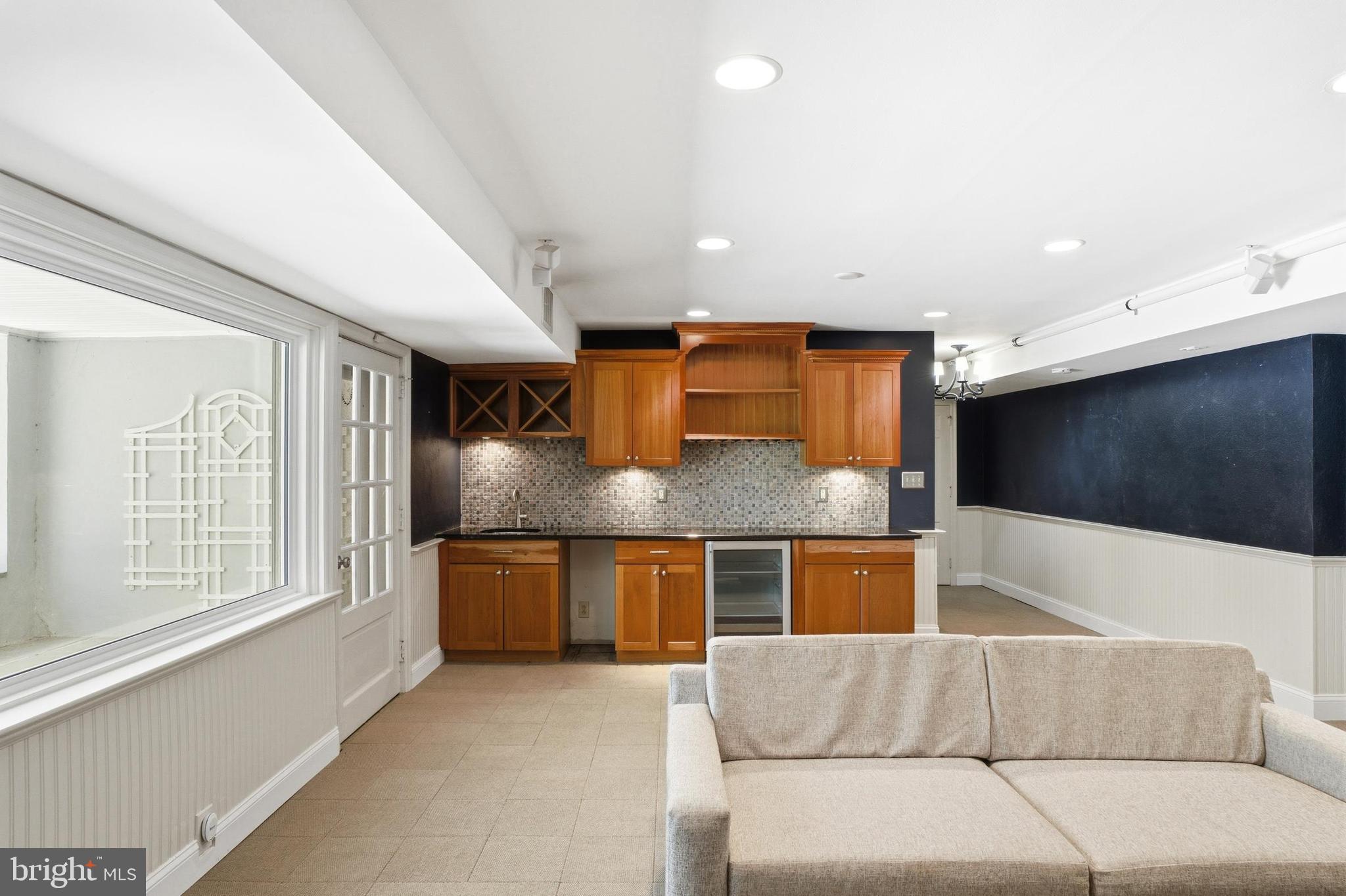 4511 Province Line Road Princeton, NJ 08540 - Photo 21 of 34 a living room with stainless steel appliances kitchen island granite countertop furniture and a flat screen tv