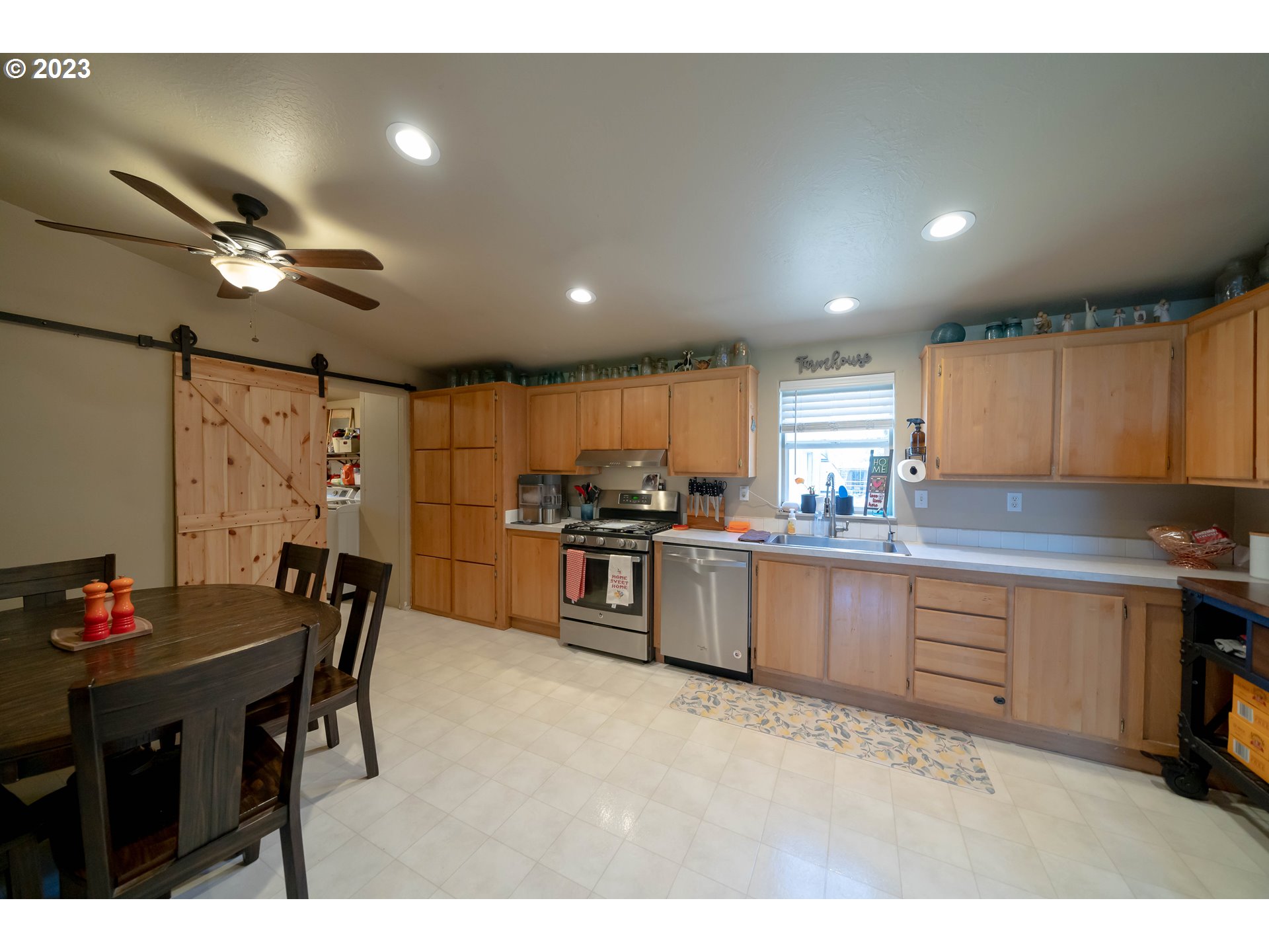40766 North Mowitch Lyons, OR 97358 - Photo 8 of 31 a kitchen with stainless steel appliances kitchen island granite countertop a table chairs sink and cabinets