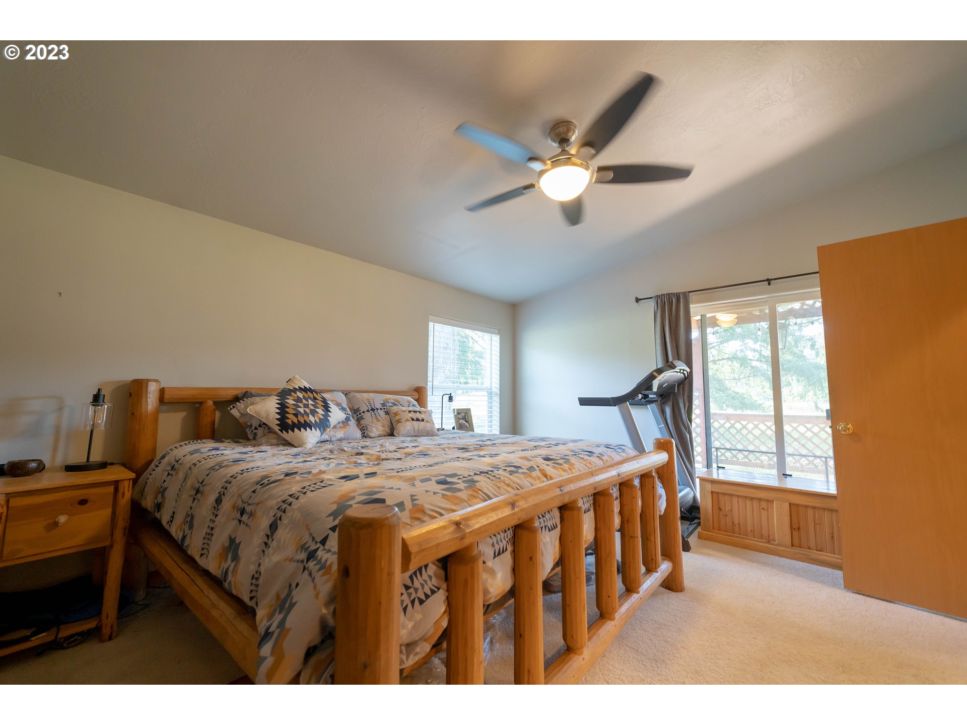 40766 North Mowitch Lyons, OR 97358 - Photo 10 of 31 a bedroom with a bed next to a window with a chandelier