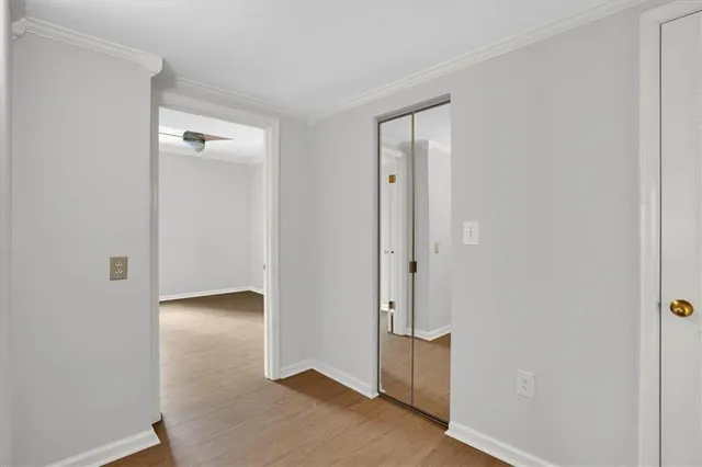 an empty room with a ceiling fan and window