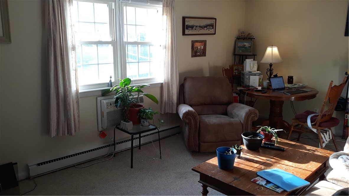 4080 Post Road, Unit 9 Warwick, RI 02886 - Photo 2 of 6 BRIGHT AND SUNNY LIVING ROOM WITH BUILT IN AC!