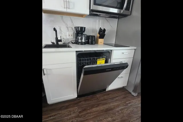 a kitchen with stainless steel appliances a refrigerator and a stove top oven