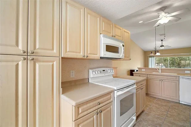 a kitchen with a white cabinets and white appliances
