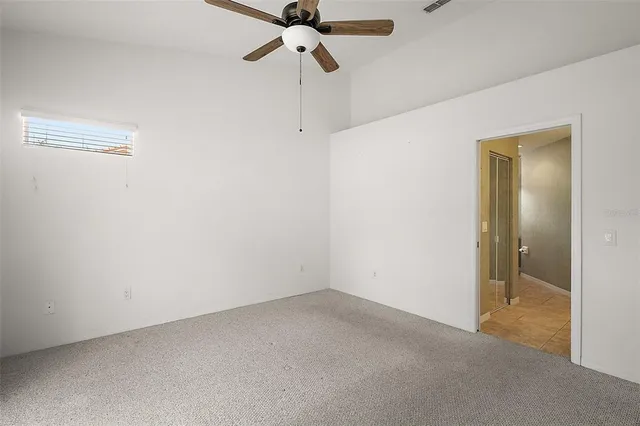 a view of empty room with a fan