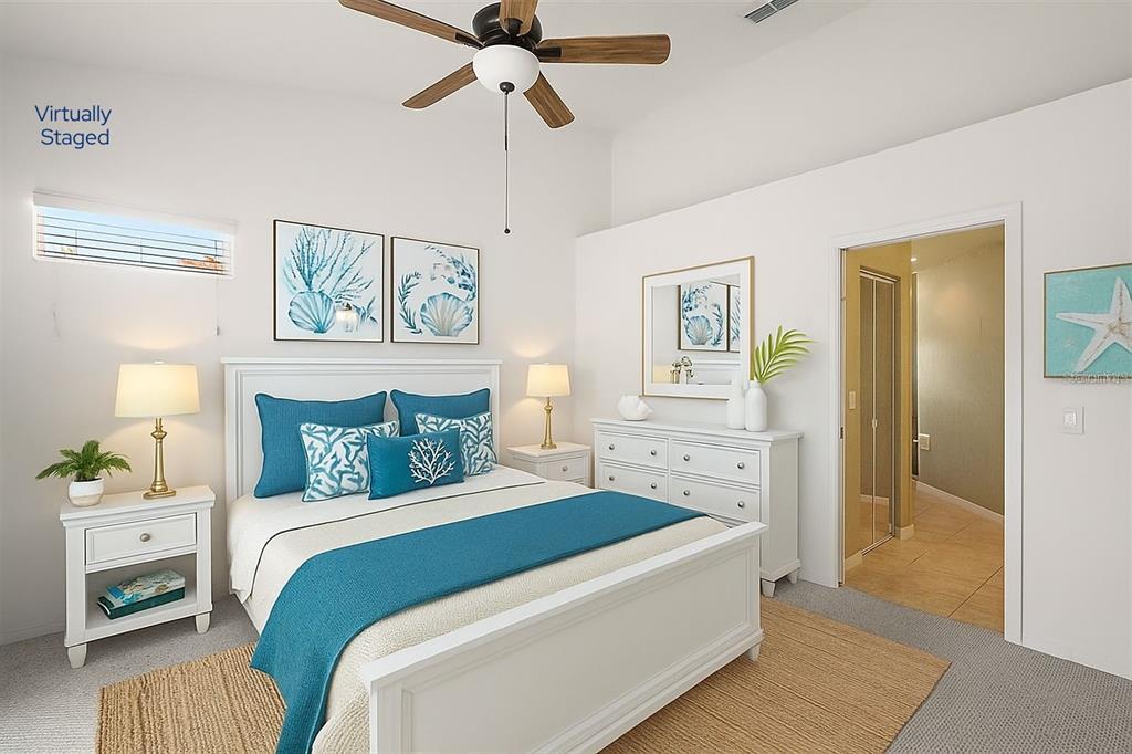 5368 Compass Point, Unit 202 Oxford, FL 34484 - Photo 19 of 33 a spacious bedroom with a bed and a chandelier