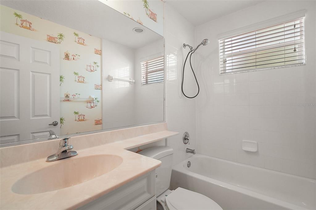 5368 Compass Point, Unit 202 Oxford, FL 34484 - Photo 25 of 33 a bathroom with a sink toilet and shower