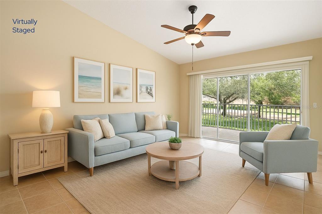 5368 Compass Point, Unit 202 Oxford, FL 34484 - Photo 6 of 33 a living room with furniture and a large window with balcony view