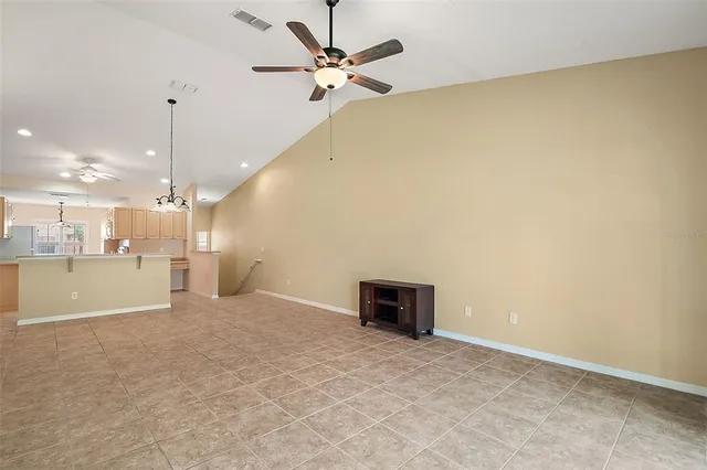 a view of a kitchen with a sink and a chandelier fan