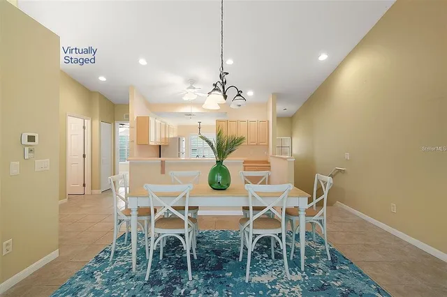 a view of a dining room with furniture and chandelier