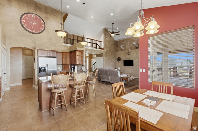2567 West Rim Rock Drive Stockton, UT 84071 - Photo 11 of 64 Open-concept living space featuring a kitchen with wood cabinetry and stainless steel appliances