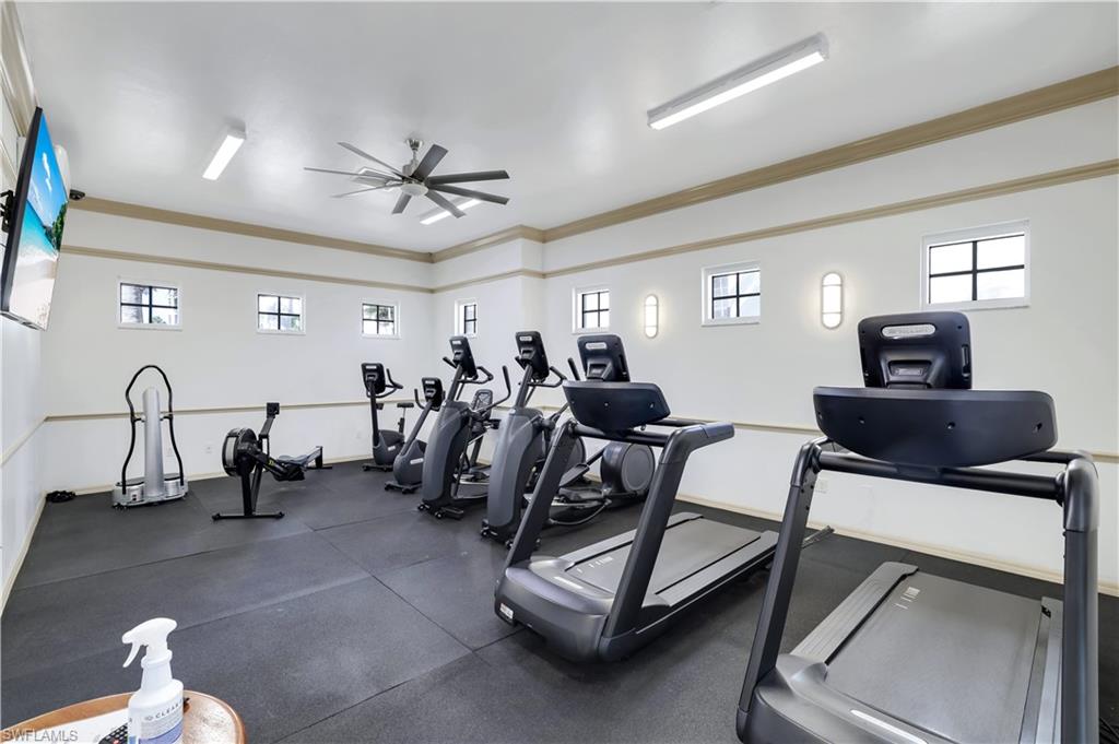 460 Launch Circle, Unit 403 Naples, FL 34108 - Photo 24 of 35 a room with gym equipment and a view of living room