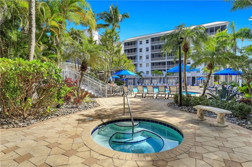 460 Launch Circle, Unit 403 Naples, FL 34108 - Photo 26 of 35 a swimming pool with outdoor seating