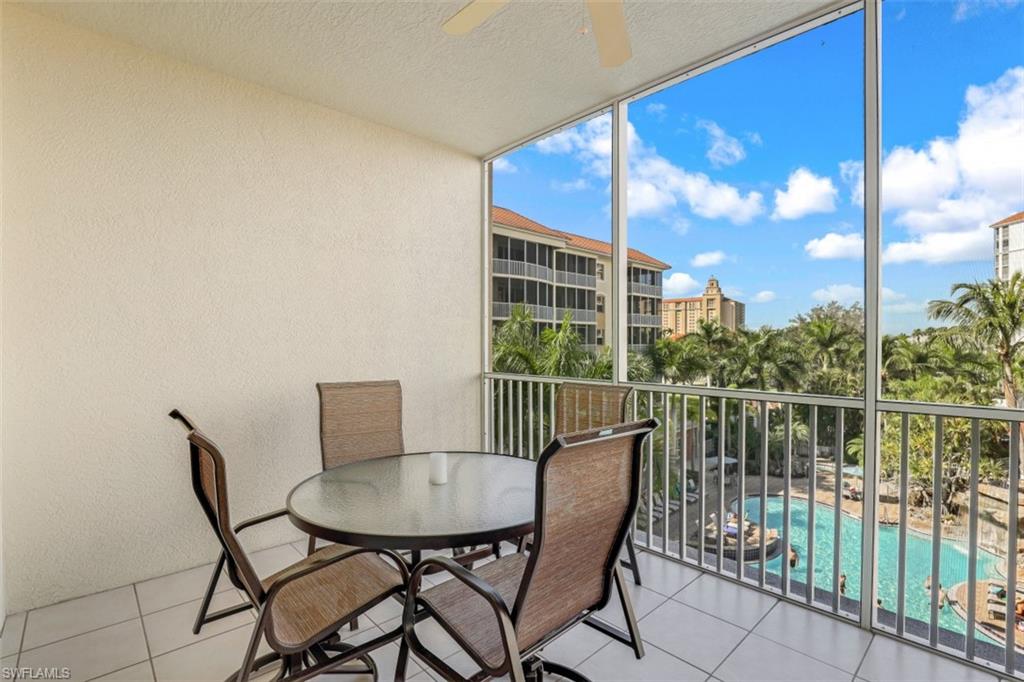 460 Launch Circle, Unit 403 Naples, FL 34108 - Photo 10 of 35 a view of a balcony with a table and chairs