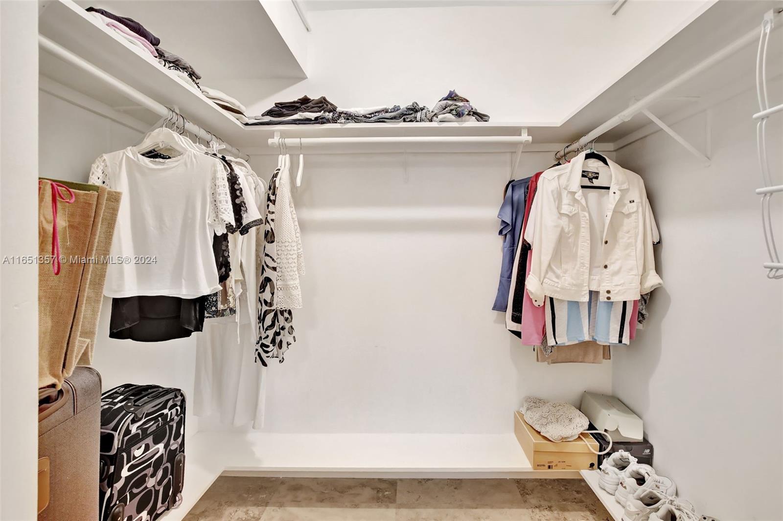 9801 Collins Avenue, Unit 3T Bal Harbour, FL 33154 - Photo 17 of 32 a view of walk in closet with clothes and shoes