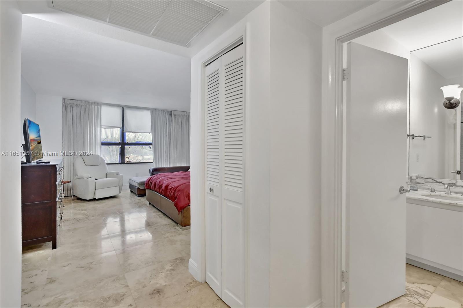 9801 Collins Avenue, Unit 3T Bal Harbour, FL 33154 - Photo 18 of 32 a bedroom with furniture and a window