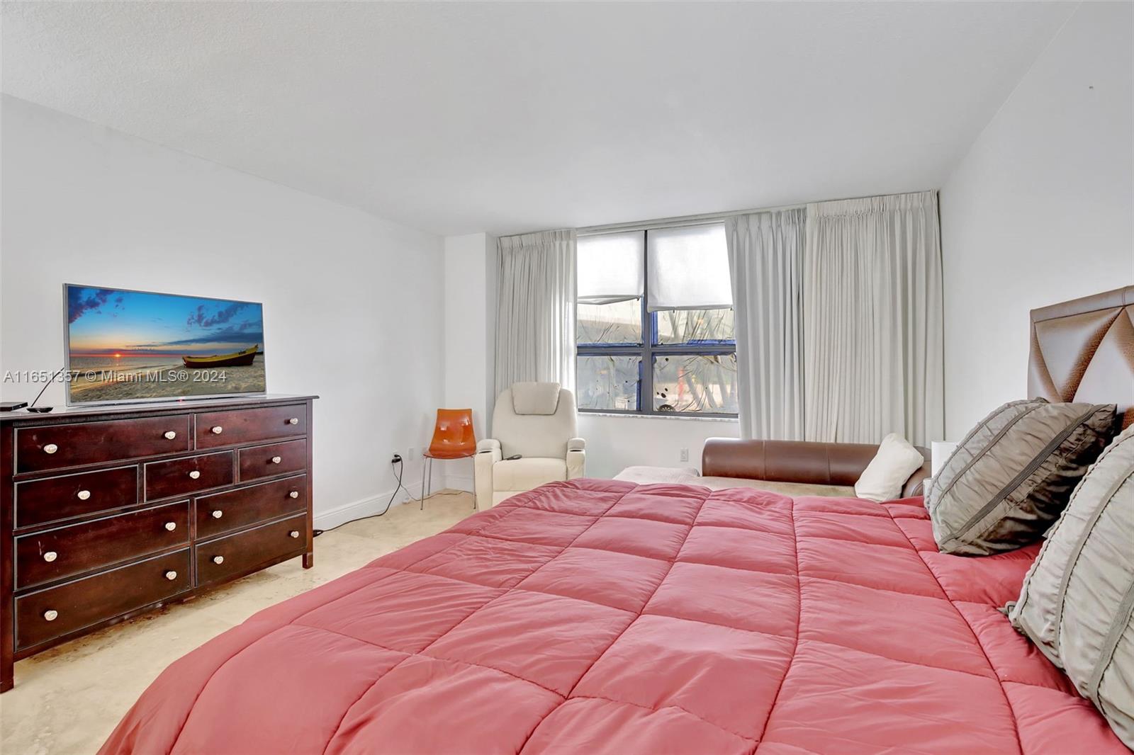 9801 Collins Avenue, Unit 3T Bal Harbour, FL 33154 - Photo 23 of 32 a bedroom with a bed and a flat screen tv