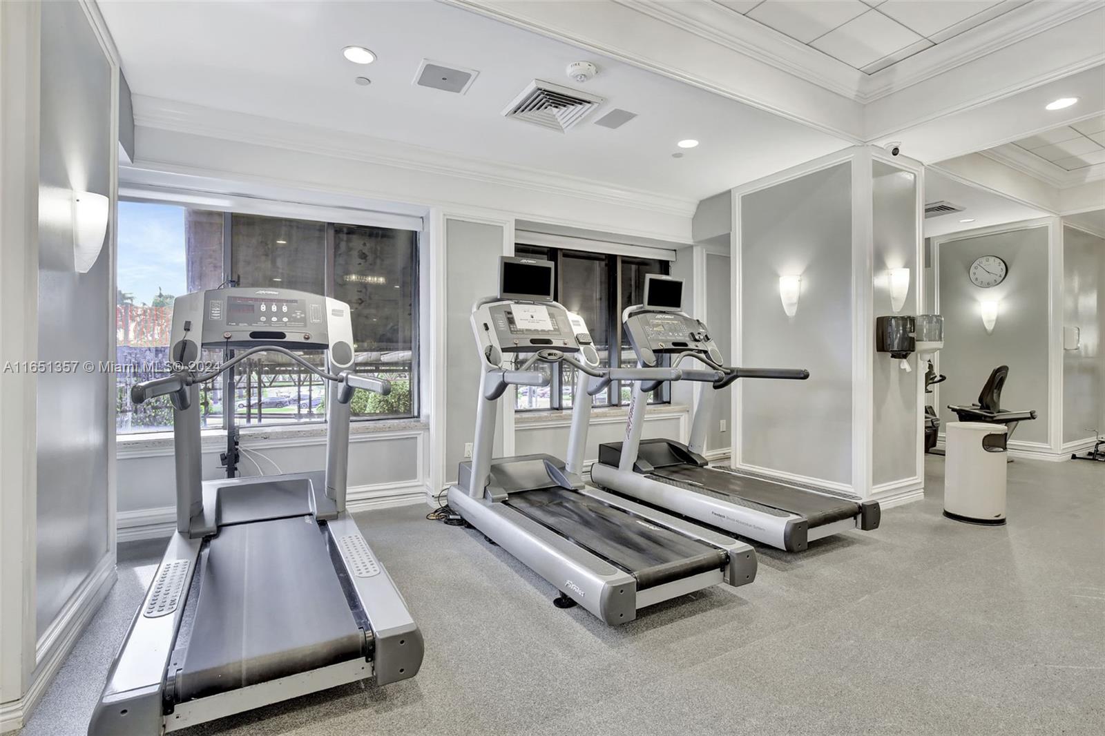 9801 Collins Avenue, Unit 3T Bal Harbour, FL 33154 - Photo 31 of 32 a room with gym equipment and a table