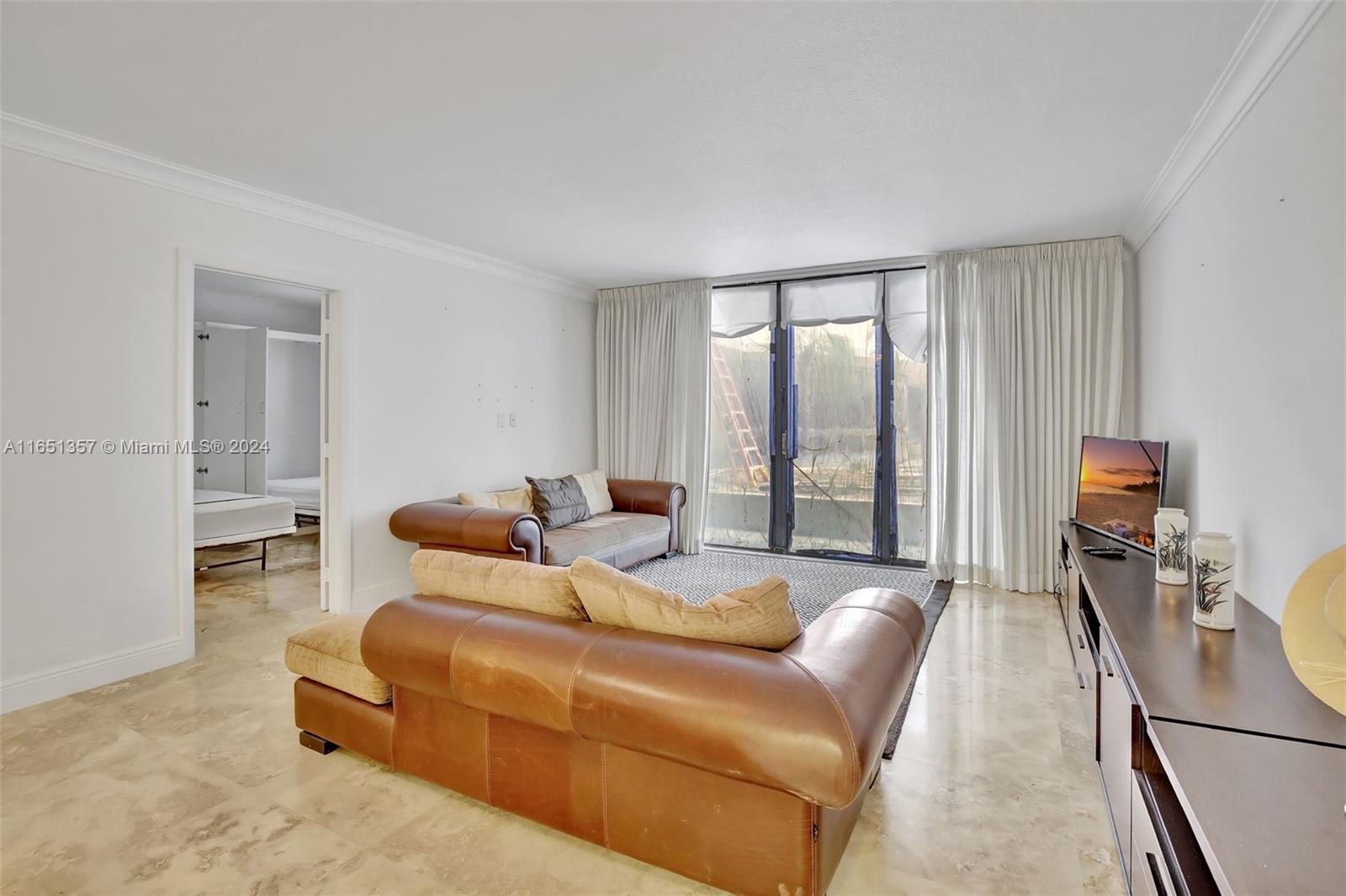 9801 Collins Avenue, Unit 3T Bal Harbour, FL 33154 - Photo 7 of 32 a living room with furniture and a large window