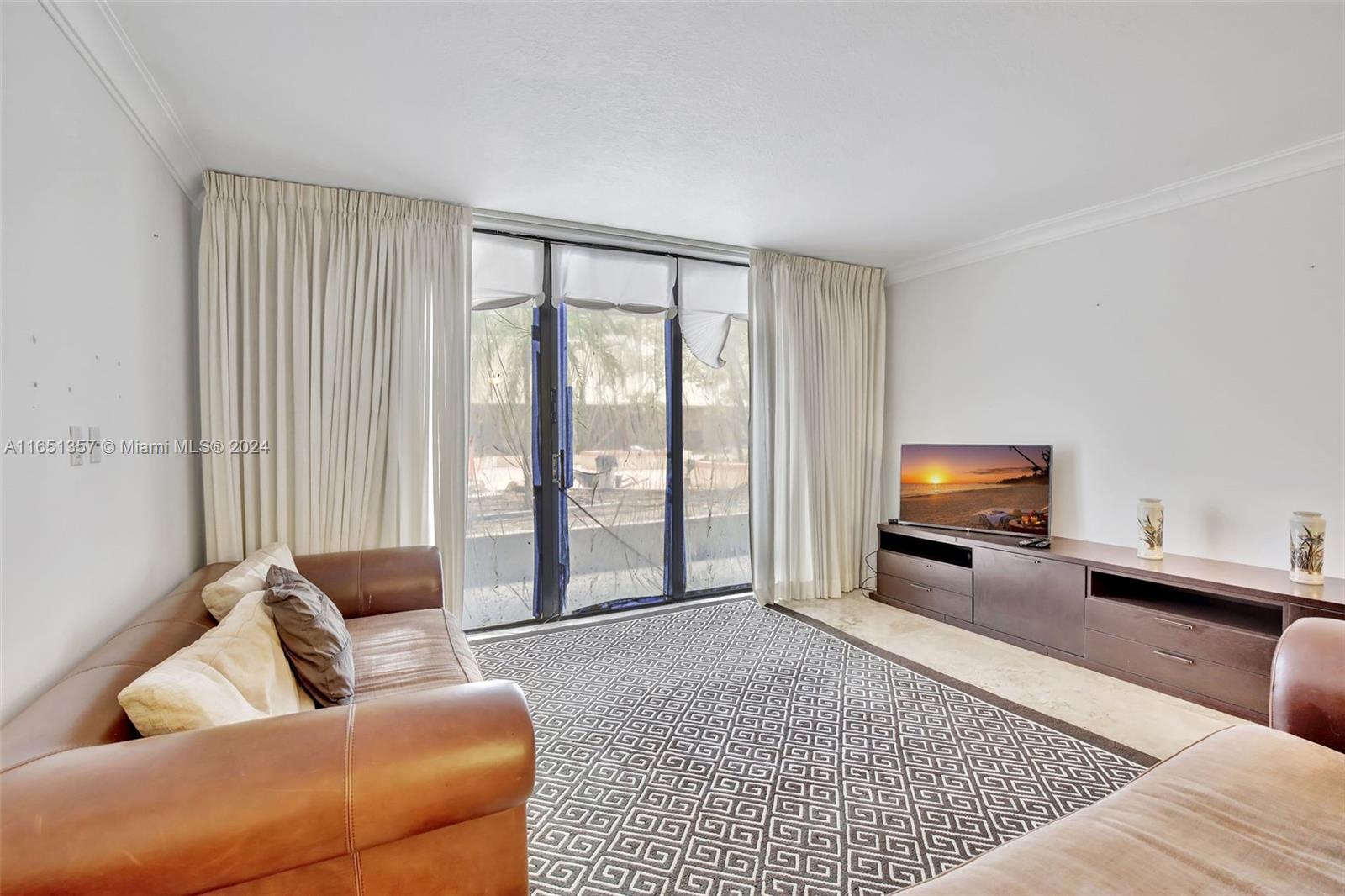 9801 Collins Avenue, Unit 3T Bal Harbour, FL 33154 - Photo 8 of 32 a living room with furniture and a window