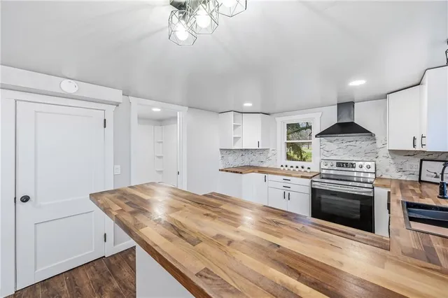 a kitchen with stainless steel appliances granite countertop a sink and stove top oven