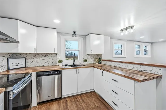 a kitchen with a sink stove and cabinets