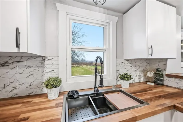 a kitchen with sink refrigerator and window