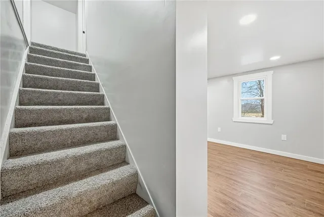 a view of staircase with white walls