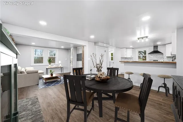 a view of a dining room with furniture and wooden floor