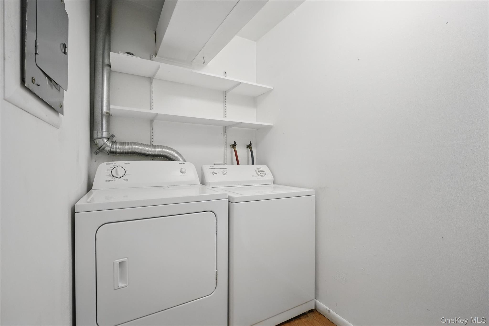 201 Commons Way, Unit E Fishkill, NY 12524 - Photo 23 of 30 Laundry area with washing machine and dryer and baseboards