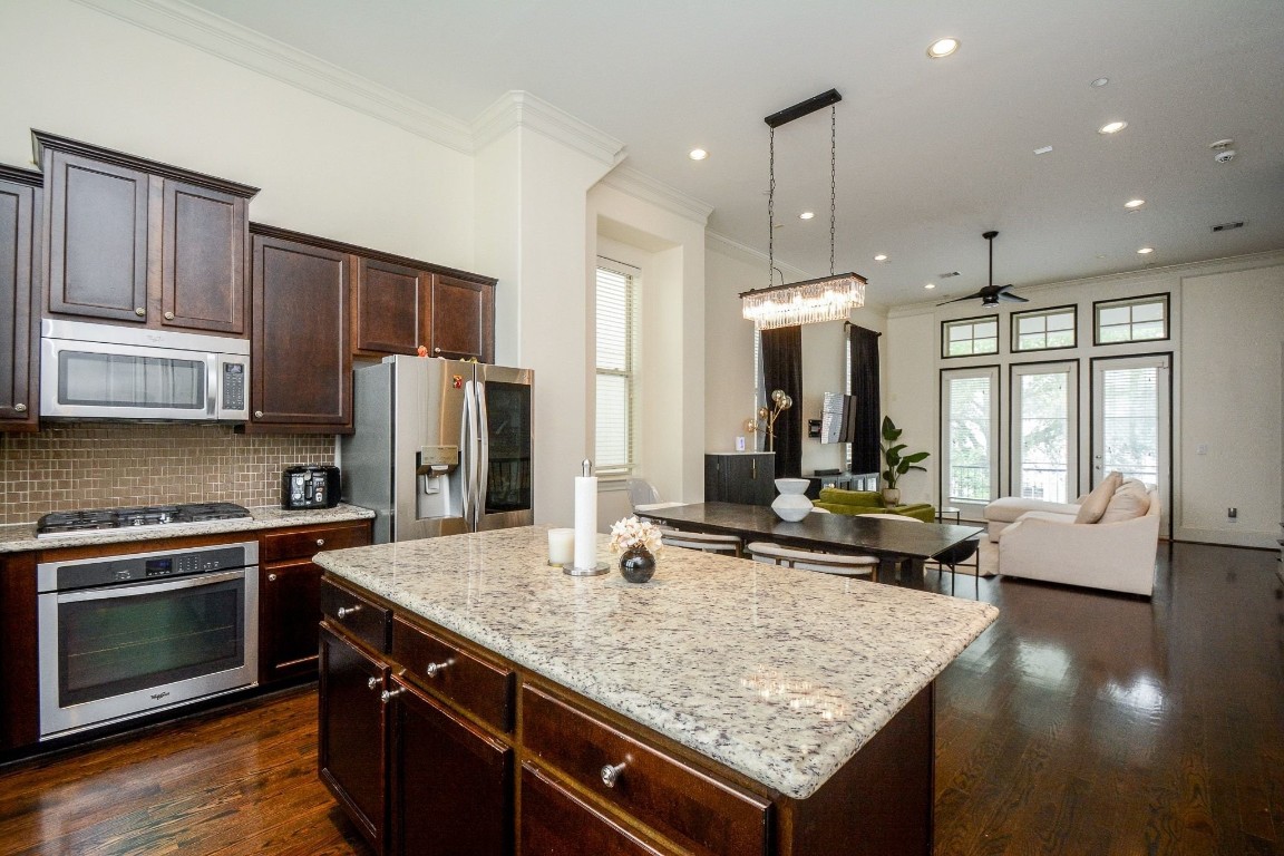 2017 Fannin Station Houston, TX 77045 - Photo 11 of 22 a kitchen with stainless steel appliances granite countertop a stove refrigerator and cabinets