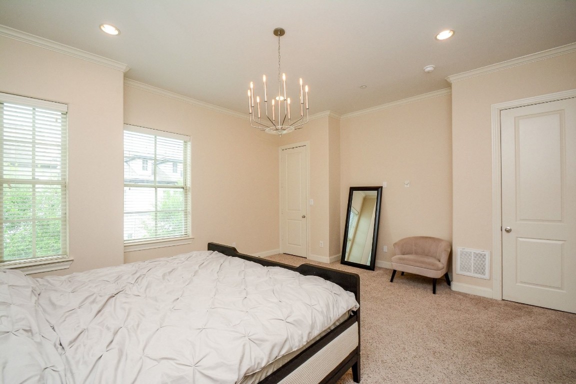 2017 Fannin Station Houston, TX 77045 - Photo 14 of 22 a bedroom with a bed and a chandelier
