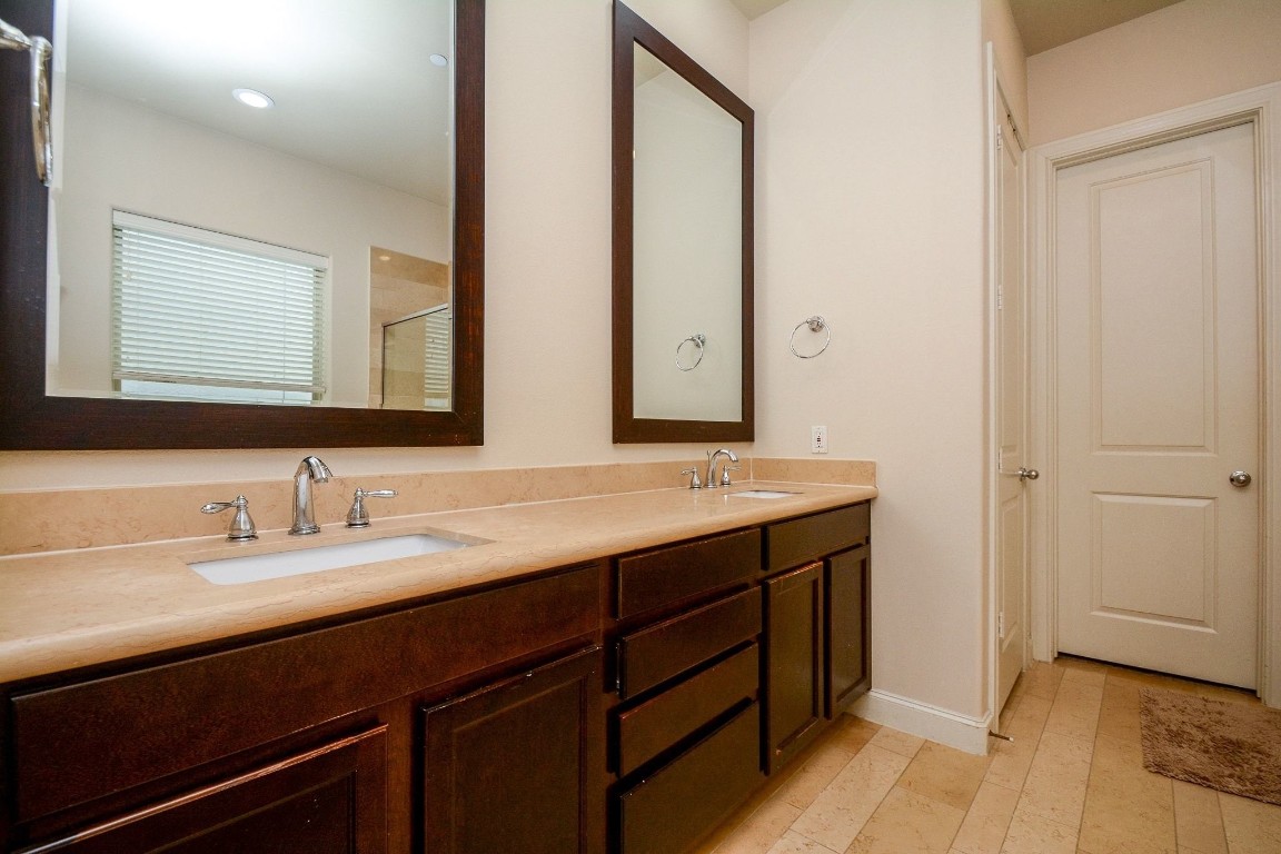2017 Fannin Station Houston, TX 77045 - Photo 15 of 22 a bathroom with a double vanity sink and a mirror
