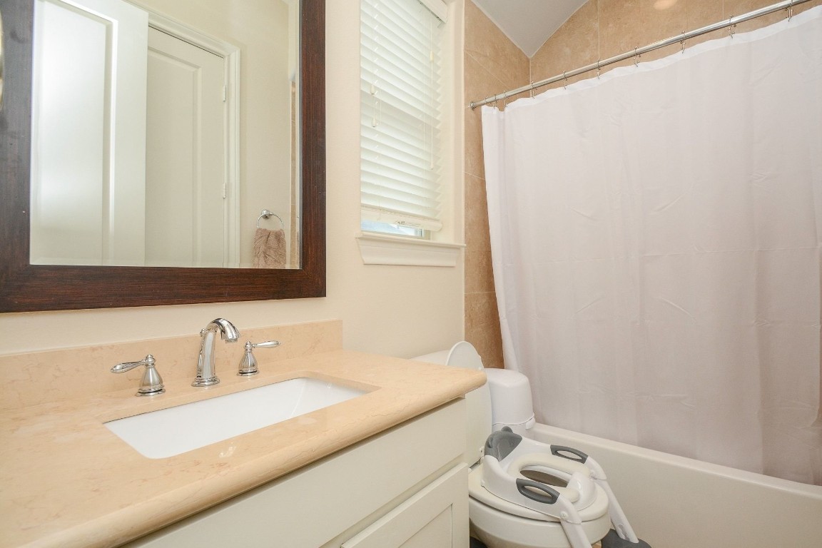 2017 Fannin Station Houston, TX 77045 - Photo 18 of 22 a bathroom with a sink and a mirror