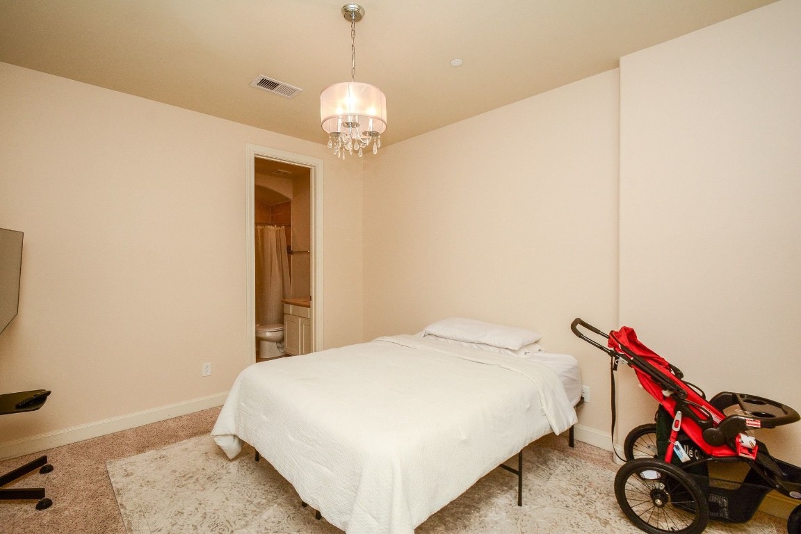 2017 Fannin Station Houston, TX 77045 - Photo 4 of 22 a bedroom with bed and a chandelier