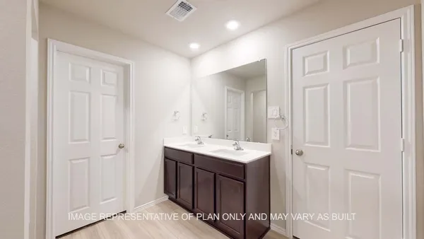 a bathroom with a double vanity sink and a mirror