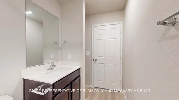 a bathroom with a sink a light fixture and a mirror
