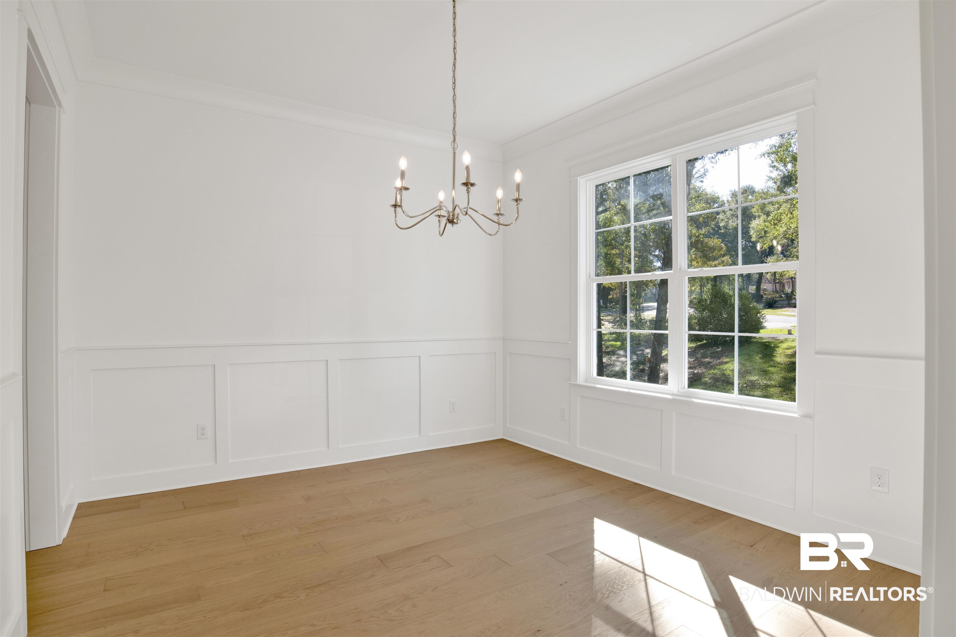 5 Long Leaf Circle Fairhope, AL 36532 - Photo 18 of 44 Empty room featuring light wood-type flooring, crown molding, and an inviting chandelier
