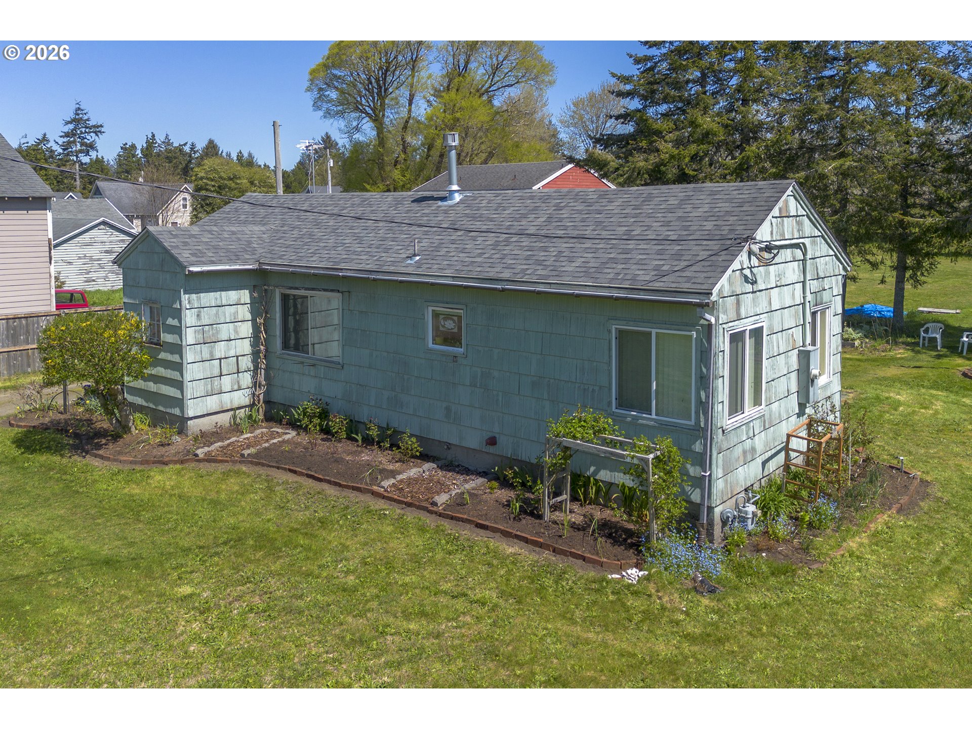 4045 Highway 101 Gearhart, OR 97138 - Photo 1 of 15 a backyard of a house with table and chairs