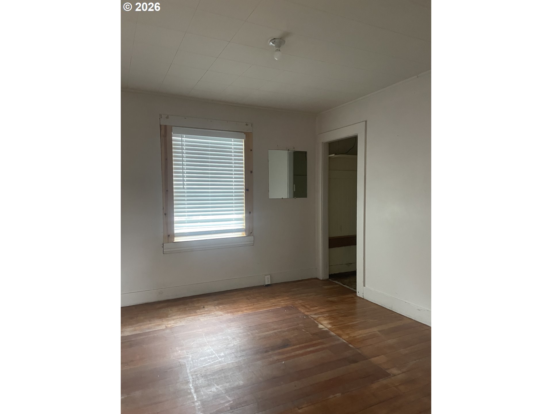 4045 Highway 101 Gearhart, OR 97138 - Photo 14 of 15 a view of an empty room with wooden floor and a window