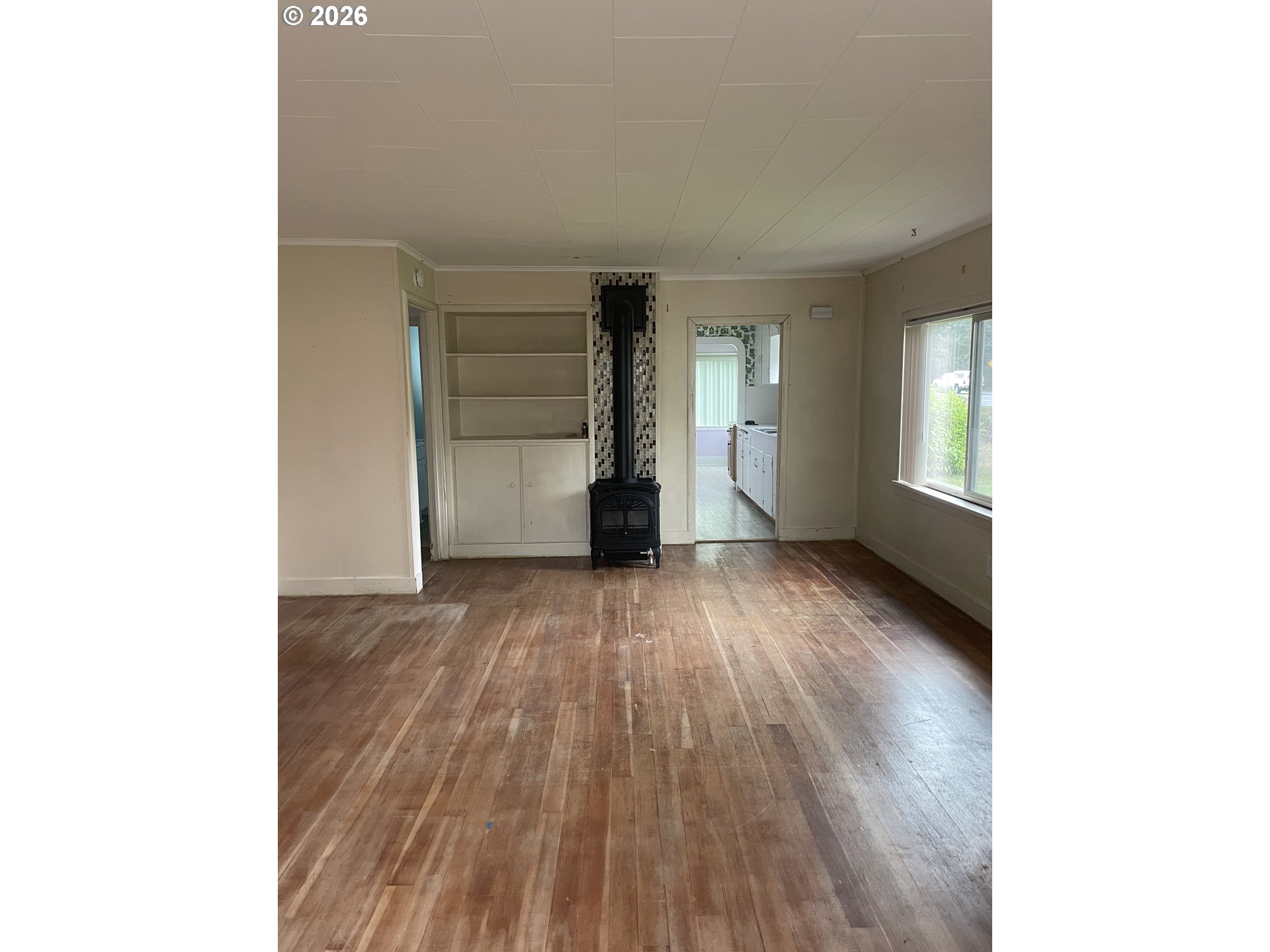 4045 Highway 101 Gearhart, OR 97138 - Photo 9 of 15 a view of an empty room with wooden floor and windows