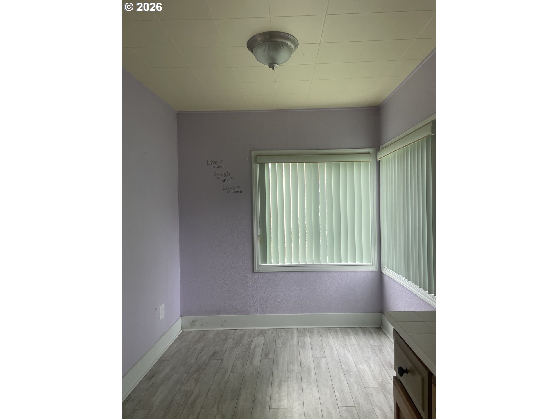 4045 Highway 101 Gearhart, OR 97138 - Photo 10 of 15 a view of an empty room with wooden floor and a window