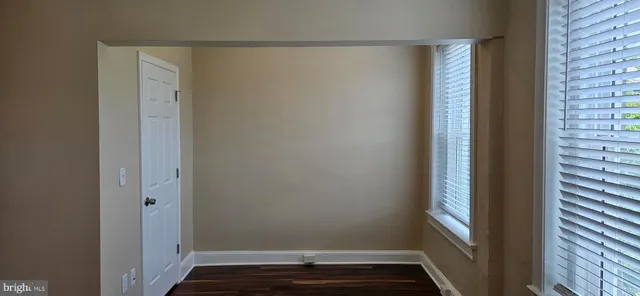 a view of small space with wooden floor and a window