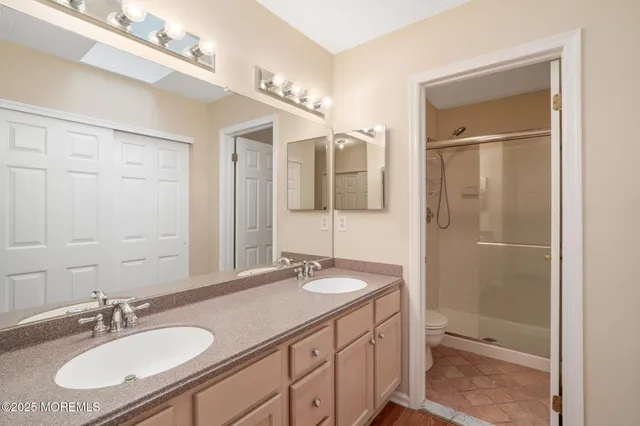 a bathroom with a sink double vanity and a mirror